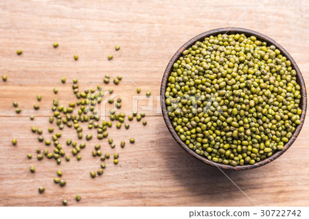 Mung beans in wooden bowl put on wooden plank background 30722742