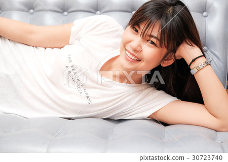 Happy smiling women relaxation on sofa Happy smiling women relaxation on sofa 30723740