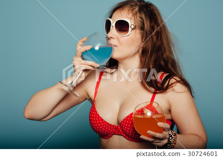 sensual woman with sunglasses drinking a cocktail 30724601