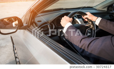 Portrait of a young handsome businessman driving a luxury sports Portrait of a young handsome businessman driving a luxury sports 30724817