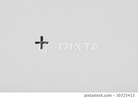 Black sign cross on white concrete wall 30725413