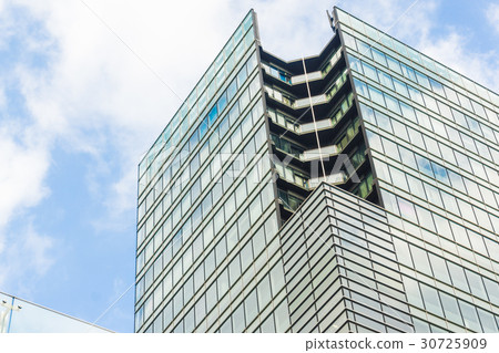 Commercial tower building window with blue sky Commercial tower building window with blue sky 30725909