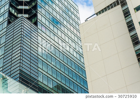 Commercial tower building window with blue sky 30725910