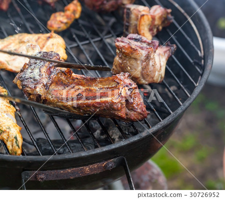 Cooking grilled red meat on barbeque Cooking grilled red meat on barbeque 30726952
