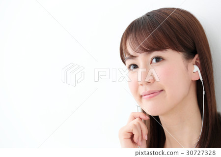 Young woman wearing earphones Young woman wearing earphones 30727328