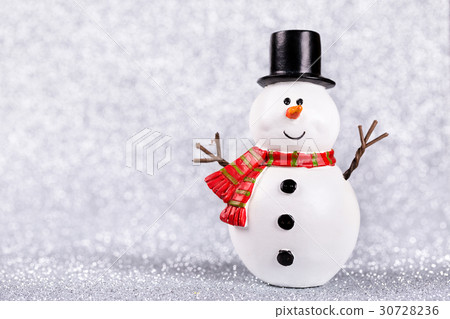 Snowman toy on shiny silver background Snowman toy on shiny silver background 30728236