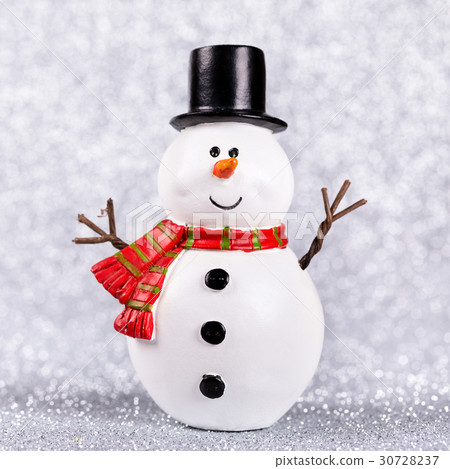 Snowman toy on shiny silver background Snowman toy on shiny silver background 30728237