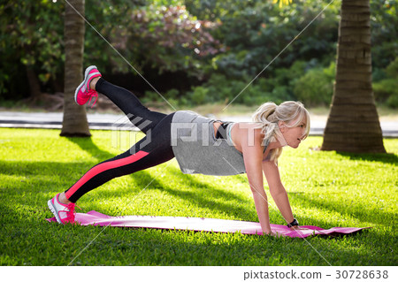 Young beautiful fitness woman doing plank position 30728638