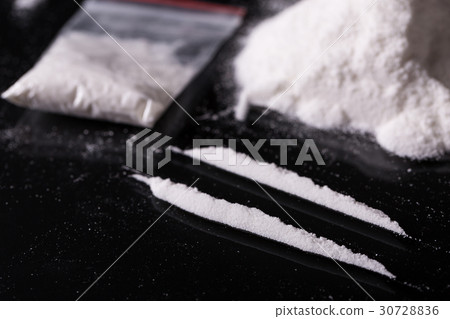 Plastic packet, two lines of cocaine on black Plastic packet, two lines of cocaine on black 30728836