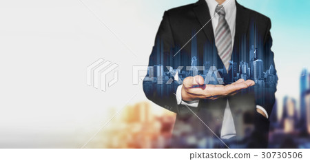 Businessman holding blue hologram of buildings 30730506