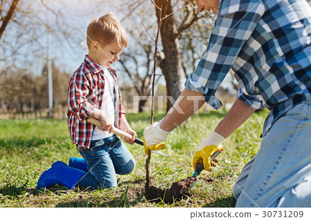 Father and son gardening together 30731209