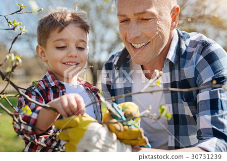 Smiling family members taking care of trees 30731239