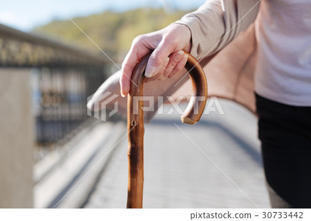 Good looking woman drawing on stick in her hands Good looking woman drawing on stick in her hands 30733442