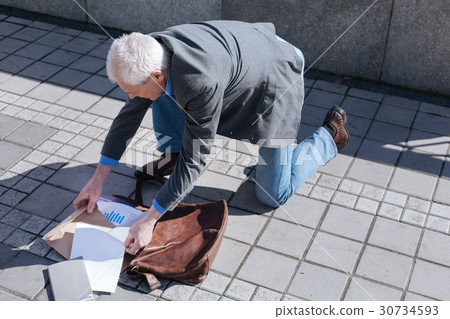 Bewildered man quickly vetting his handbag in the Bewildered man quickly vetting his handbag in the 30734593
