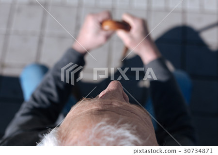 Wrinkly pensioner peering in the open air Wrinkly pensioner peering in the open air 30734871