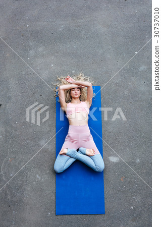 Young slim blond woman making yoga exercises 30737010