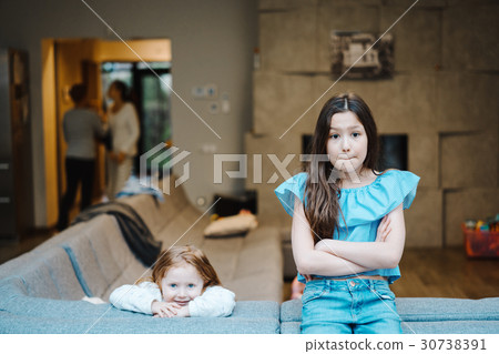 Elder and younger daughter on the big couch 30738391