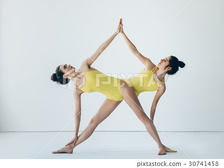 Two beautiful women doing yoga asana 30741458