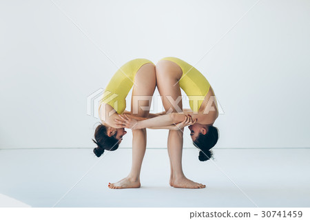 Two young women doing yoga asana 30741459