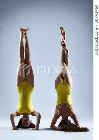 Two young women doing yoga asana 30741460