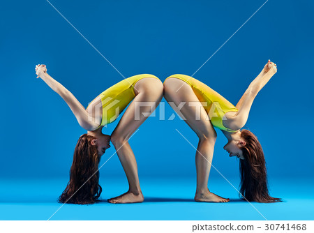 Two women doing yoga asana Two women doing yoga asana 30741468