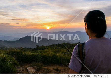 Woman watching sunset 30742125