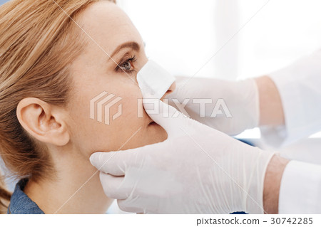 Close up of womans face with a medical dressing 30742285