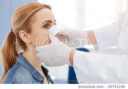 Nice male doctor putting a medical dressing 30742286