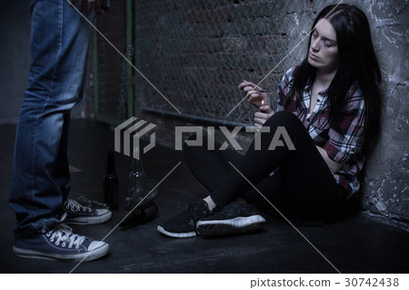 Frustrated addict preparing drug dose in the dark 30742438