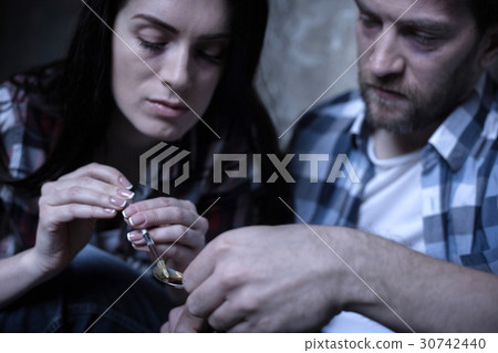 Apathetic freaks preparing heroine over the flame Apathetic freaks preparing heroine over the flame 30742440