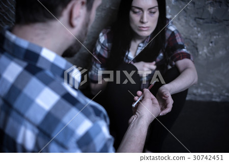 Young addicted couple sharing syringe with drug 30742451
