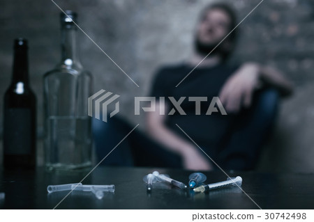 Several medical syringes lying in the dark lighted Several medical syringes lying in the dark lighted 30742498