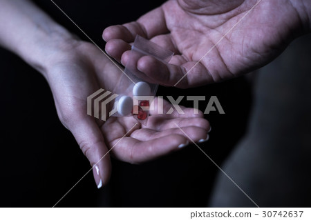 Drug addicted people exchanging packet with drugs Drug addicted people exchanging packet with drugs 30742637