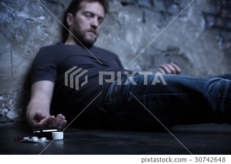 Exhausted self murderer lying on the ground in the Exhausted self murderer lying on the ground in the 30742648