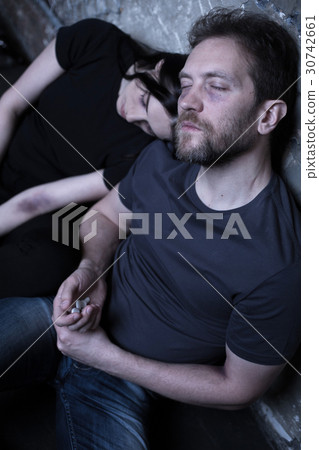 Exhausted couple of junkies using drugs outdoors Exhausted couple of junkies using drugs outdoors 30742661
