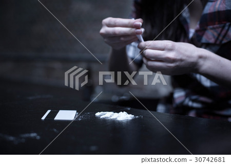 Skilled obsessed woman preparing dose of drugs Skilled obsessed woman preparing dose of drugs 30742681