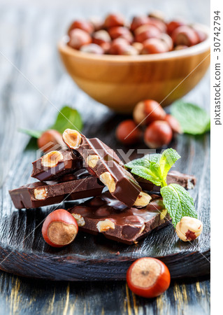 Dark chocolate with hazelnuts and mint leaves. 30742794
