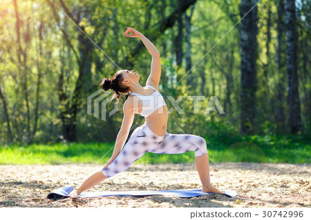 Young woman doing yoga exercises in the summer 30742996