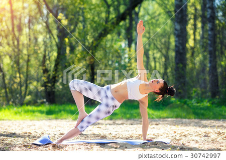 Young woman doing yoga exercises in the summer 30742997