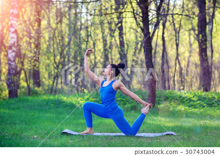 Young woman doing yoga exercises in the summer Young woman doing yoga exercises in the summer 30743004