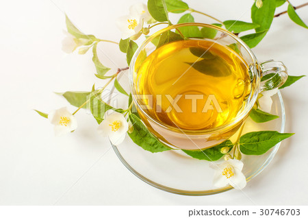 Cup of tea with jasmine on table close-up Cup of tea with jasmine on table close-up 30746703