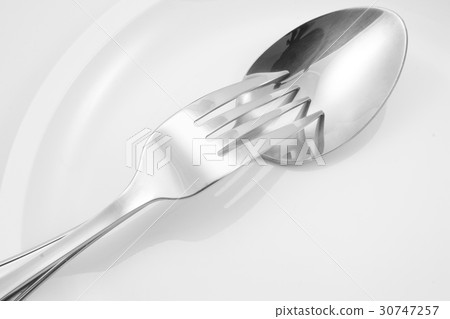 Fork and spoon on a plate with napkin Fork and spoon on a plate with napkin 30747257