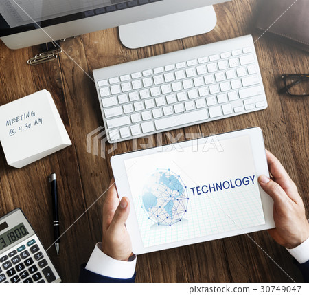 Hands working on digital device network graphic overlay 30749047
