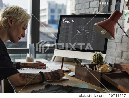 Woman checking appointment on personal organizer schedule 30751327