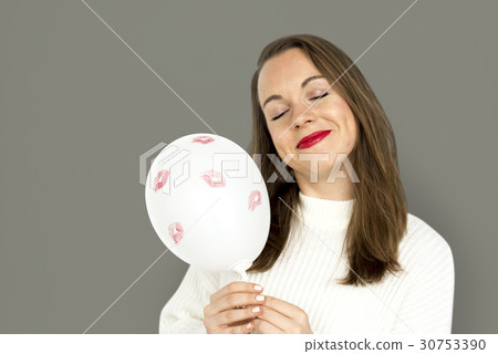Young girl smiling holding a balloon 30753390