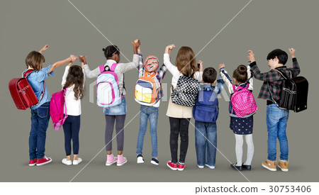Rear view group of diverse kids standing in a row holdings hands in the air Rear view group of diverse kids standing in a row holdings hands in the air 30753406