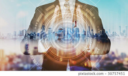 Businessman with city hologram, technology concept Businessman with city hologram, technology concept 30757451