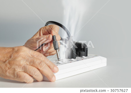 Elderly mistake plugging electrical type. 30757627