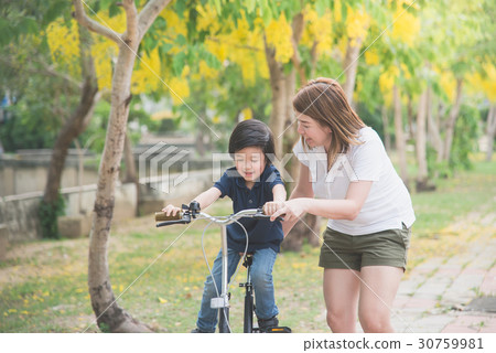 Asian  father and son riding bicycle 30759981