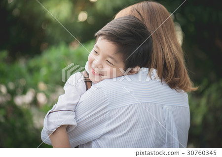 asian mother hugging with her son in the park asian mother hugging with her son in the park 30760345